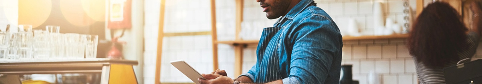 a small business owner viewing a tablet