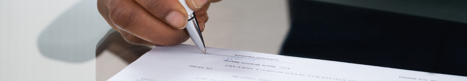 a person writing a business check