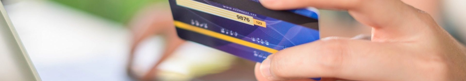 a person holding a credit or debit card