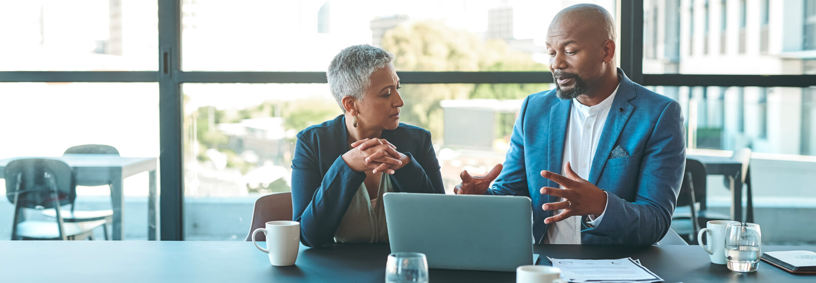 Two business people looking at a laptop